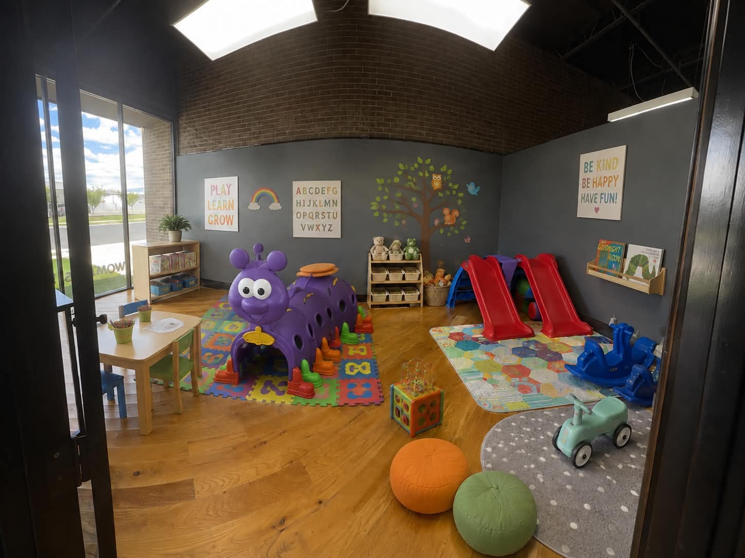 Bright, colorful indoor playroom at the Flex-Care center with slides, toys, and learning activities